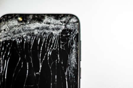 Mobile phone with broken screen on white background.Closeup.の写真素材