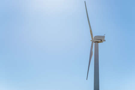 Wind power,one wind turbine and blue sky.wind power concept with copy space. Technology in nature...