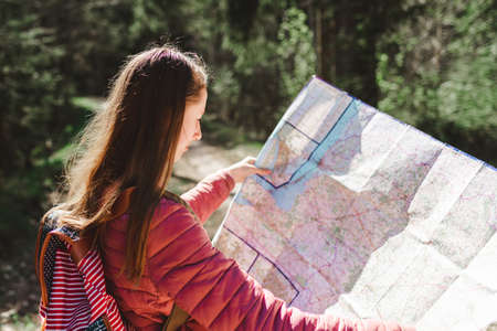 One young teen lookng at map. Adventure, travel, tourism concept. holiday break. Summer Spring vacation.Side view,Closeup.の写真素材