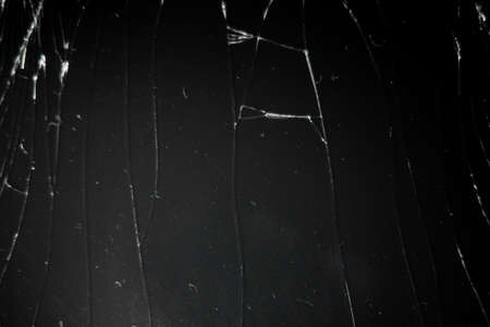 Cracked Glass Of Display Screen.Closeup of a broken smartphone with cracked screen.Macro shot.