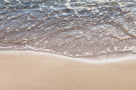 Soft wave of the sea on the sandy beach.Soft focus,blurred image.Copy space.の写真素材