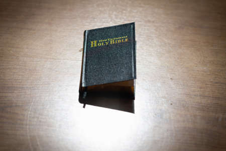 Bible in the light wooden background. The Holy Bible.The Old Holly Bible closed.Black holly Bible on...