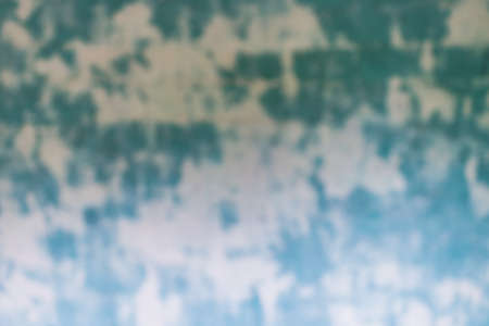 Blurred Blue green spoted exposed wall texture.Empty old stained art texture of plaster brick wall background.の写真素材