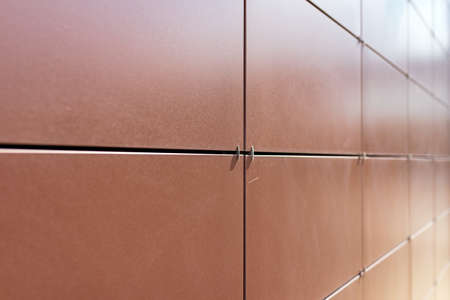 Background texture of rectangular smooth brown tiles. Stone street covering of wall, masonry of...