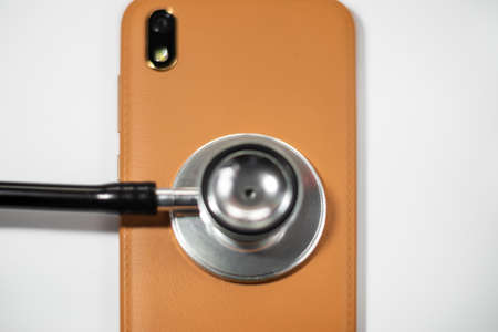 Stethoscope with smart phone. on white, abstract background to solution or key of solution problem for smart phone.Stethoscope with mobile phone on white background.の写真素材
