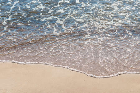 Soft wave of the sea on the sandy beach.Soft focus,blurred image.Copy space.
