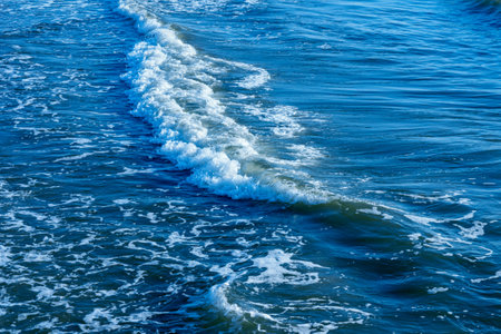 Areal shot of deep blue and rough sea with lot of sea spray.Blue background.Soft focus,blurred image.の写真素材