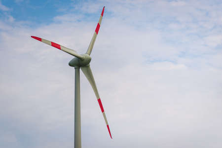 Single windmill generating electricity against blue sky.Beautiful wind turbine on blue sky and white clouds background. eco friendly electric power source.の写真素材