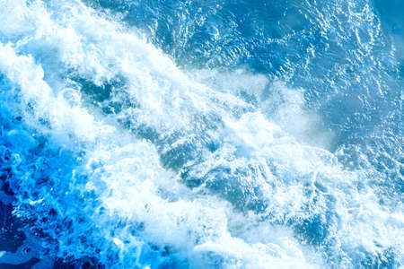 Areal shot of deep blue and rough sea with lot of sea spray.Blue background.Soft focus,blurred...
