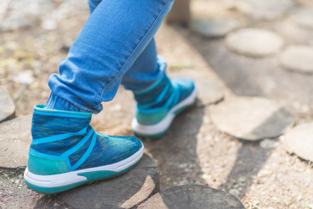 woman walk in to the wild. Travel adventure and freedom concept.Woman walking outdoors, shoes closeupの写真素材