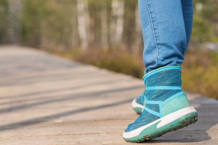 woman walk in to the wild. Travel adventure and freedom concept.Woman walking outdoors, shoes...