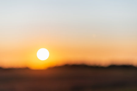Blurred sunset on the summer landscape.Summer holiday concept. blurry beautiful sunlight and golden sunset background.の写真素材