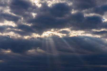 Rays of light shining throug dark clouds.Beautiful dramatic sky with sun rays.dramatic sky sun rays.の写真素材