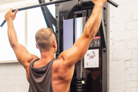 Muscular man working out in gym doing exercises,Exercise for triceps in the gym. strong male naked...