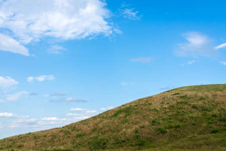 Summer mountain green grass and blue sky white clouds summer landscapeの写真素材