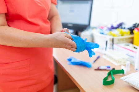 doc ready with gloves in the laboratory clinic hospital virology examination to prepare analysis blood probe covid test results positive negative.Closeup.の写真素材
