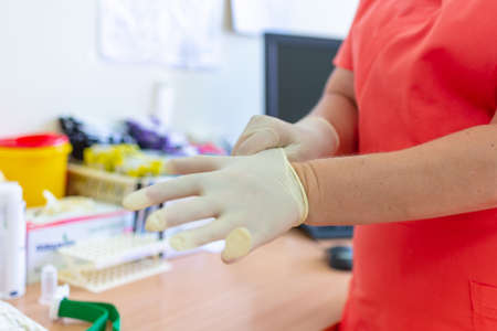 doc ready with gloves in the laboratory clinic hospital virology examination to prepare analysis blood probe covid test results positive negative.Closeup.の写真素材