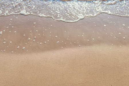 Soft wave of the sea on the sandy beach.Soft focus,blurred image.Copy space.の写真素材