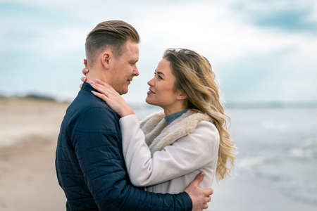 Young couple enjoying on a coast and enjoying each other.Summer,spring,autumn vacation.の写真素材