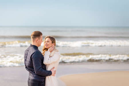 Young couple enjoying on a coast and enjoying each other.Summer,spring,autumn vacation.の写真素材