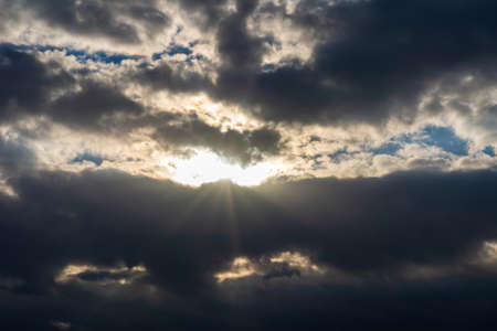 Rays of light shining throug dark clouds.Beautiful dramatic sky with sun rays.dramatic sky sun rays.の写真素材