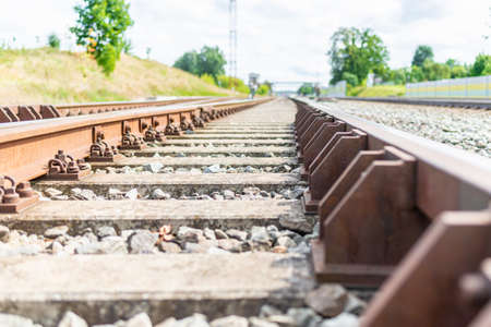 Railway track details closeup photo with selective focus.Close-up view of railway bolts.Summer day details of railway tracks.の写真素材
