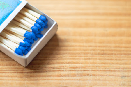 Wooden safety matchsticks stacked in cardboard matchbox on old wooden background.Box of matches.Wooden table.copy space.Open box of matches.closeup.Selective focus.の写真素材