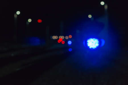 Night empty railroad tracks near train station with lights in dark night.A train station near...