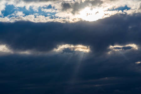 Rays of light shining throug dark clouds.Beautiful dramatic sky with sun rays.dramatic sky sun rays.の写真素材