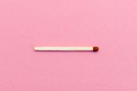 Closeup match on a pink background with clipping path.matchstick flat lay,copy space,selective...