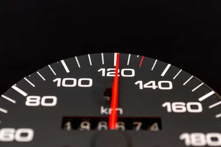 Car speedometer with the needle pointing a high speed at blackground, Speedometer with a red arrow indicating speeding, conceptual image for excessive speeding or careless driving concept.Close-up.の写真素材
