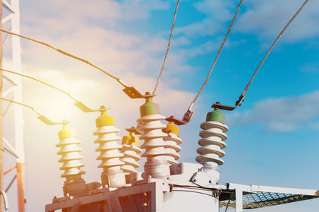 High voltage electric generator insulators.Detail of high voltage circuit breaker in a power substation.high voltage circuit breaker in a power substation on a summer day.Closeup.の写真素材