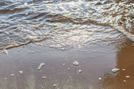 Soft wave of the sea on the sandy evening beach.Soft focus,blurred image.Copy space.