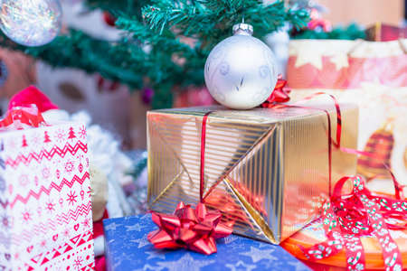 Decorated gift boxes under the Christmas tree.New Year gifts, different present boxes under...