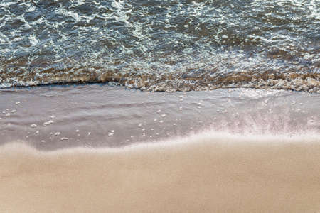Soft wave of the sea on the sandy beach.Soft focus,blurred image.Copy space.の写真素材
