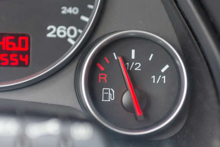 Fuel gauge with red indicator at empty level.Close-up car dash board petrol meter, fuel gauge, with over full gasoline in car. Clip.Gasoline sensorの写真素材