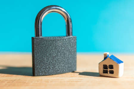 House locked with padlock. House is closed on a lock.Blue blurred background.Selective...