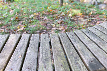 wooden bench in the autumn park, designed for recreation in the park,closeup.Copy space,blurred background.の写真素材