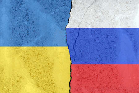 Ukraine vs Russia national flags on a broken weathered cracked cement wall background,two states...