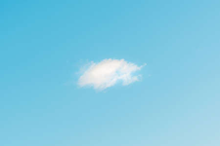 Nice one white fluffy cloud in the blue sky.Blue sky background with cloud.の写真素材