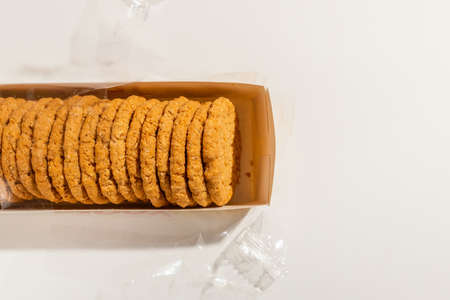 Cookies, Biscuits Pack on White Background.Pack of biscuits, wrapped with transparent plastic.Studio...