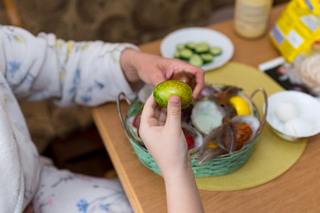 9 year old boy, mother having fun with Beating Easter eggs, traditional action in Lithuania for Eastern holidayの写真素材