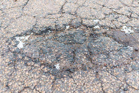 Damaged road. Deep crack on the asphalt. Closeup.view from above.の写真素材