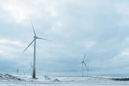 Winter shot a few windmill and blue cloudy sky wind generators in winter.の写真素材
