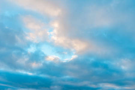 Beautiful sun leaving bright golden shades. clouds in sky winter evening.
