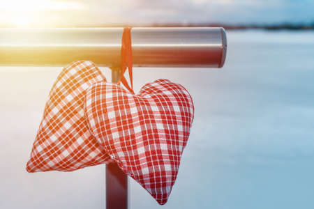 Couple Valentine s hearts cloudy sunrise blurred background against winter landscape.Valentine s Day Concept.の写真素材