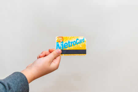Used New York Metro card holding young boy kid child hand. Metro Card New York City Subway Paying Fare Turnstile MTA Transit System Commute.Copy space.Indoors shot.Telsiai,Lithuania 22-12-2021のeditorial素材