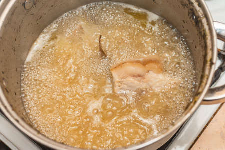 boiling a piece of meat. Boiling broth.boil pork in steam pot, selective focus.close up.の写真素材