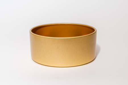 Yellow golden round empty metal box on white background.Soft focus,copy space.の写真素材