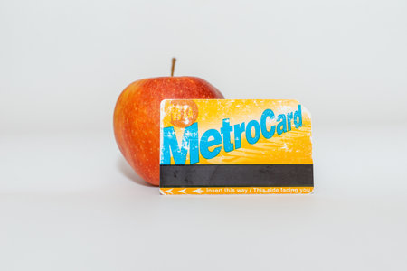 New York Metro card and apple flat lay on the gray background.Metro Card New York City Subway Paying...